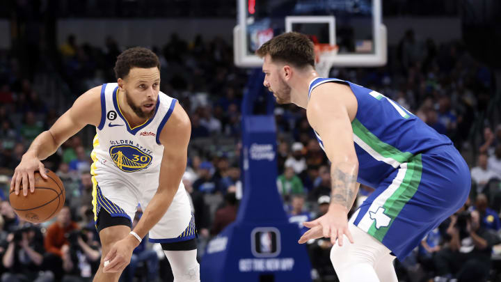 Nov 29, 2022; Dallas, Texas, USA;  Golden State Warriors guard Stephen Curry (30) dribbles as Dallas Mavericks guard Luka Doncic (77) defends during the first quarter at American Airlines Center. Mandatory Credit: Kevin Jairaj-USA TODAY Sports