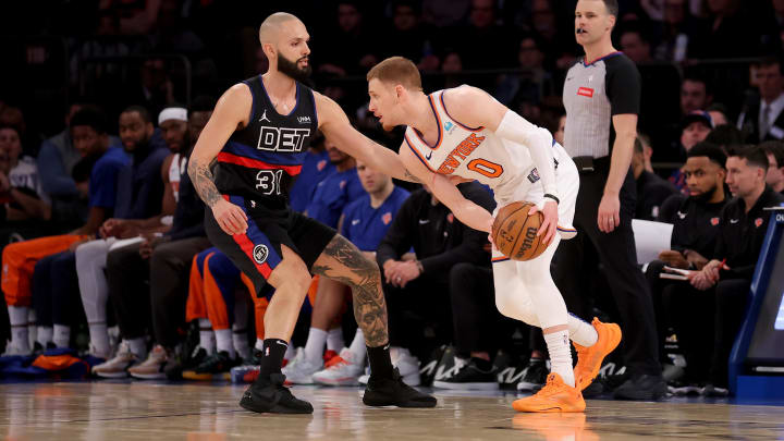 Mar 25, 2024; New York, New York, USA; New York Knicks guard Donte DiVincenzo (0) controls the ball against Detroit Pistons guard Evan Fournier (31) during the fourth quarter at Madison Square Garden. Mandatory Credit: Brad Penner-USA TODAY Sports