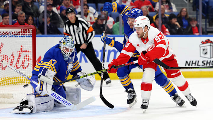Dec 9, 2024; Buffalo, New York, USA;  Detroit Red Wings right wing Alex DeBrincat (93) scores a goal on Buffalo Sabres goaltender James Reimer (47) during the first period at KeyBank Center. Mandatory Credit: Timothy T. Ludwig-Imagn Images