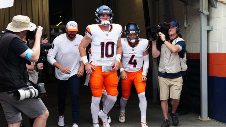 Aug 18, 2024; Denver, Colorado, USA; Denver Broncos quarterback Bo Nix (10) and quarterback Zach Wilson (4) before the preseason game against the Green Bay Packers at Empower Field at Mile High. Mandatory Credit: Ron Chenoy-USA TODAY Sports