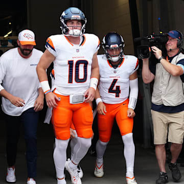 Aug 18, 2024; Denver, Colorado, USA; Denver Broncos quarterback Bo Nix (10) and quarterback Zach Wilson (4) before the preseason game against the Green Bay Packers at Empower Field at Mile High. Mandatory Credit: Ron Chenoy-Imagn Images