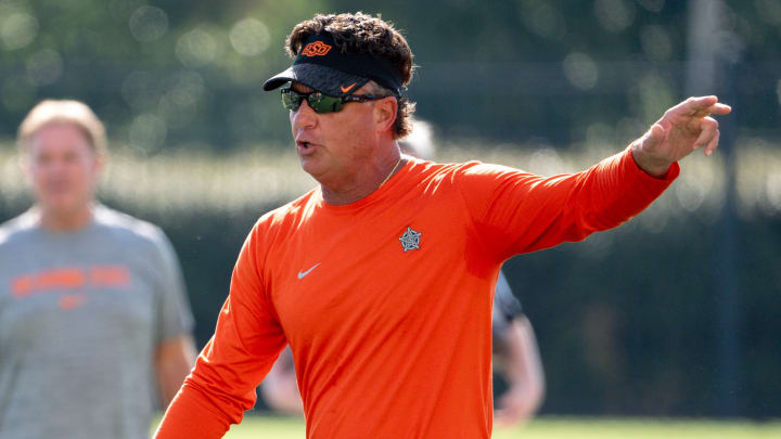 Head coach Mike Gundy walks on the field during an Oklahoma State football practice in Stillwater, Okla., on Saturday, Aug. 3, 2024.