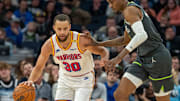 Golden State Warriors guard Stephen Curry dribbles the ball up the court past Minnesota Timberwolves forward Jaden McDaniels in the second half at Target Center in Minneapolis on Jan. 15, 2025.