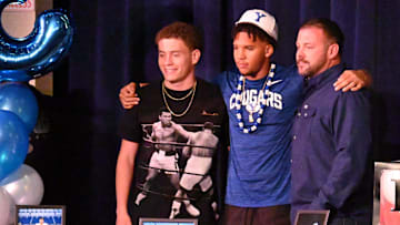 Oak Hills' LaMason Waller III, center, poses for a photo with former teammate Jake Higgs, left, on Tuesday, Dec. 3, 2024. Oak Hills hosted a signing event for five players that will be signing a National Letter of Intent during the three-day Early Signing Period.