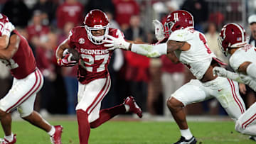 Oklahoma Sooners running back Gavin Sawchuk (27) tries to get away from Alabama Crimson Tide linebacker Jihaad Campbell (11) during a college football game between the University of Oklahoma Sooners (OU) and the Alabama Crimson Tide at Gaylord Family - Oklahoma Memorial Stadium in Norman, Okla., Saturday, Nov. 23, 2024. Oklahoma won 24-3.