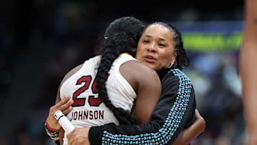 South Carolina Gamecocks head coach Dawn Staley hugs guard Raven Johnson.