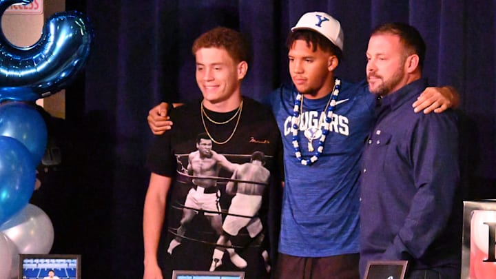 Oak Hills' LaMason Waller III, center, poses for a photo with former teammate Jake Higgs, left, on Tuesday, Dec. 3, 2024. Oak Hills hosted a signing event for five players that will be signing a National Letter of Intent during the three-day Early Signing Period.