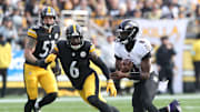 Nov 17, 2024; Pittsburgh, Pennsylvania, USA;  Baltimore Ravens quarterback Lamar Jackson (8) runs the ball against Pittsburgh Steelers linebacker Patrick Queen (6) during the first quarter at Acrisure Stadium. Mandatory Credit: Charles LeClaire-Imagn Images