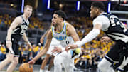 Apr 19, 2025; Indianapolis, Indiana, USA;  Indiana Pacers guard Tyrese Haliburton (0) dribbles the ball while Milwaukee Bucks forward Giannis Antetokounmpo (34)  defends in the second half at Gainbridge Fieldhouse. Mandatory Credit: Trevor Ruszkowski-Imagn Images