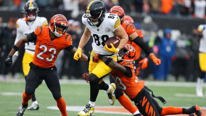 Nov 26, 2023; Cincinnati, Ohio, USA;  Pittsburgh Steelers tight end Pat Freiermuth (88) makes the catch as Cincinnati Bengals safety Dax Hill (23)  and safety Nick Scott (33) tackle during the first quarter at Paycor Stadium. Mandatory Credit: Joseph Maiorana-USA TODAY Sports