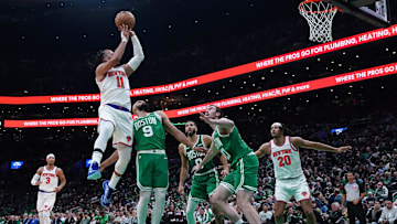 Oct 22, 2024; Boston, Massachusetts, USA; New York Knicks guard Jalen Brunson (11) shoots against Boston Celtics guard Derrick White (9) in the second half at TD Garden. Mandatory Credit: David Butler II-Imagn Images