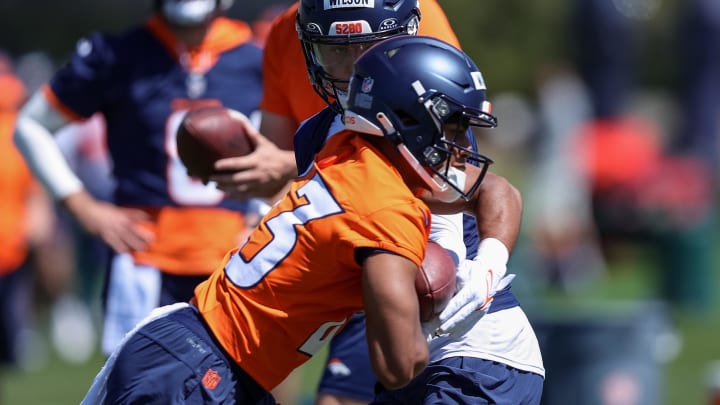 May 23, 2024; Englewood, CO, USA; Denver Broncos quarterback Zach Wilson (4) and running back Blake Watson (43) during organized team activities at Centura Health Training Center. Mandatory Credit: Isaiah J. Downing-USA TODAY Sports