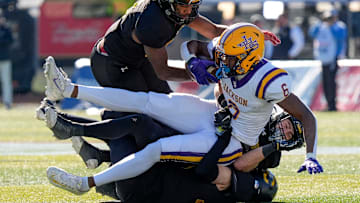 Dec 6, 2024; Birmingham, AL, USA; A trio of Cherokee County defenders bring down Jackson's Keeyun Chapman (6) at Protective Stadium in the AHSAA 4A State Championship game.
