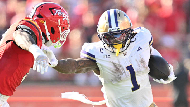 Oct 4, 2025; College Park, Maryland, USA;  Washington Huskies running back Jonah Coleman (1) stiff arms Maryland Terrapins linebacker Trey Reddick (3)  while picking up yardage in the first half at SECU Stadium. 