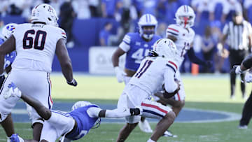 Oct 12, 2024; Provo, Utah, USA; Arizona Wildcats quarterback Noah Fifita (11) breaks a tackle by Brigham Young Cougars cornerback Marque Collins (2) during the fourth quarter at LaVell Edwards Stadium. Mandatory Credit: Rob Gray-Imagn Images