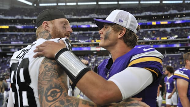 Minnesota Vikings quarterback J.J. McCarthy (9) and Las Vegas Raiders defensive end Maxx Crosby (98) react after the game at 