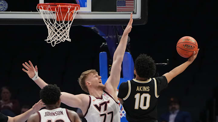 Mar 10, 2026; Charlotte, NC, USA; Wake Forest Demon Deacons guard Sebastian Akins (10) shoots as Virginia Tech Hokies center Antonio Dorn (77) defends in the second half at Spectrum Center. Mandatory Credit: Bob Donnan-Imagn Images