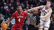 Rutgers guard Ace Bailey (4) goes to the basket in front of Illinois forward Ben Humrichous (3) and a referee