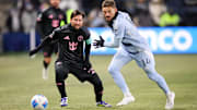 Feb 19, 2025; Kansas City, Kansas, USA; Inter Miami forward Lionel Messi (10) and Sporting Kansas City defender Tim Leibold (14) go after the ball during the first half at Children's Mercy Park. Mandatory Credit: William Purnell-Imagn Images