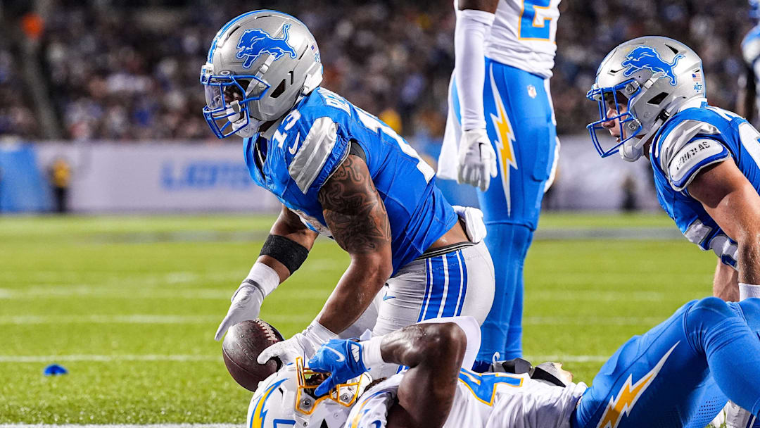 Detroit Lions running back Craig Reynolds (13) runs for a touchdown against LA Chargers safety Kendall Williamson (40) during the first half of the Hall of Fame Game at Tom Benson Hall of Fame Stadium in Canton, Ohio on Thursday, July 31, 2025.