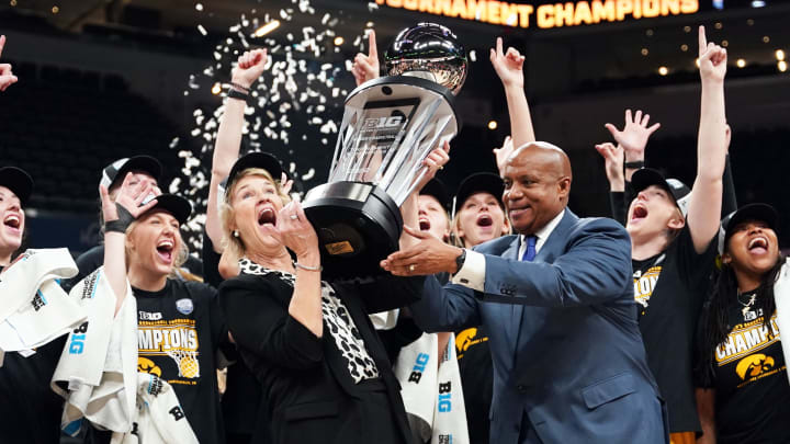 The Iowa Hawkeyes and head coach Lisa Bluder celebrates their Big Ten Tournament victory and automatic bid to the 2022 NCAA Women's Tournament.