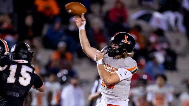 Lakeland Dreadnaughts quarterback Zander Smith (15) throws the ball under pressure from Buchholz Bobcats outside linebacker Thomas Weinhardt (15) during the first half in the Semifinals of the 2023 FHSAA Football State Championships at Citizens Field in Gainesville, FL on Friday, December 1, 2023. [Matt Pendleton/Gainesville Sun]