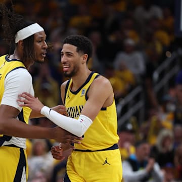 May 27, 2025; Indianapolis, Indiana, USA; Indiana Pacers guard Tyrese Haliburton (0) reacts with center Myles Turner (33) after shooting a three point basket during the second quarter against the New York Knicks of game four of the eastern conference finals for the 2025 NBA Playoffs at Gainbridge Fieldhouse. Mandatory Credit: Trevor Ruszkowski-Imagn Images
