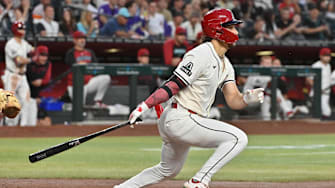 Apr 24, 2025; Phoenix, Arizona, USA;  Arizona Diamondbacks outfielder Alek Thomas (5) hits an RBI double in the second inning against the Tampa Bay Rays at Chase Field. Mandatory Credit: Matt Kartozian-Imagn Images