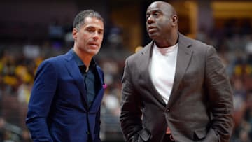 Los Angeles Lakers general manager Rob Pelinka speaks with former president of basketball operations Magic Johnson at Honda Center.