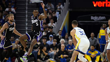 Oct 11, 2024; San Francisco, California, USA; Sacramento Kings guard De'Aaron Fox (5) leaves his feet to attempt to block a pass by Golden State Warriors guard Stephen Curry (30) during the first quarter at Chase Center. Mandatory Credit: D. Ross Cameron-Imagn Images