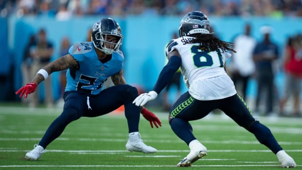 Tennessee Titans cornerback Elijah Molden readies to make a tackle against Seattle Seahawks wide receiver Laviska Shenaut.