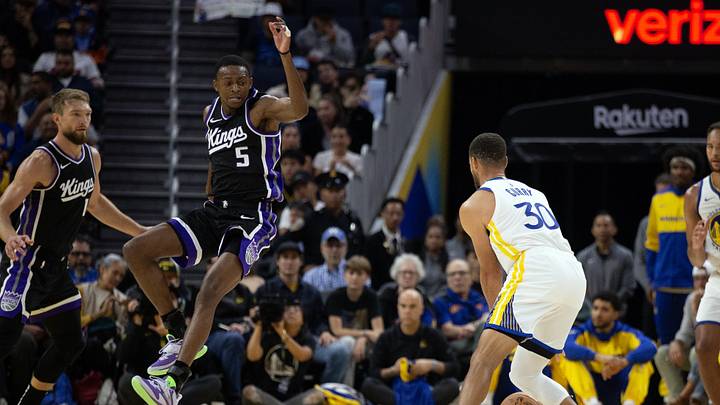 Oct 11, 2024; San Francisco, California, USA; Sacramento Kings guard De'Aaron Fox (5) leaves his feet to attempt to block a pass by Golden State Warriors guard Stephen Curry (30) during the first quarter at Chase Center. Mandatory Credit: D. Ross Cameron-Imagn Images