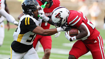 Aug 30, 2025; Lubbock, Texas, USA;  Texas Tech Red Raiders running back J’Koby Williams (20) rushes against Arkansas-Pine Bluff Golden Lions defensive safety Na’il Johnson (38) in the first half at Jones AT&T Stadium. Mandatory Credit: Michael C. Johnson-Imagn Images