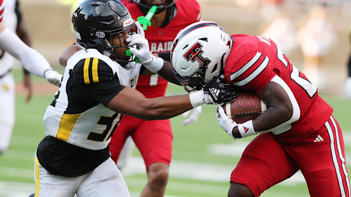 Aug 30, 2025; Lubbock, Texas, USA;  Texas Tech Red Raiders running back J’Koby Williams (20) rushes against Arkansas-Pine Bluff Golden Lions defensive safety Na’il Johnson (38) in the first half at Jones AT&T Stadium. Mandatory Credit: Michael C. Johnson-Imagn Images