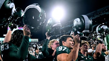 Oct 19, 2024; East Lansing, Michigan, USA;  Michigan State Spartans place kicker Jonathan Kim (97) sings with his team as he celebrates kicking six field goals against the Iowa Hawkeyes at Spartan Stadium. Mandatory Credit: Dale Young-Imagn Images