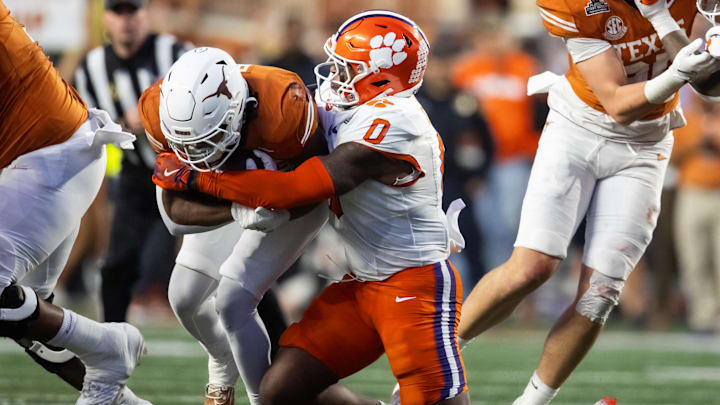 Dec 21, 2024; Austin, Texas, USA; Clemson Tigers linebacker Barrett Carter (0) tackles Texas Longhorns running back Jaydon Blue (23) during the CFP National playoff first round at Darrell K Royal-Texas Memorial Stadium. Mandatory Credit: Mark J. Rebilas-Imagn Images
