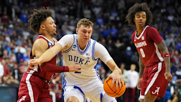 Mar 29, 2025; Newark, NJ, USA; Duke Blue Devils forward Cooper Flagg (2) drives to the basket against Alabama Crimson Tide guard Mark Sears (1) during the second half in the East Regional final of the 2025 NCAA tournament at Prudential Center. Mandatory Credit: Robert Deutsch-Imagn Images