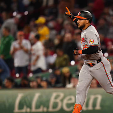 Sep 11, 2024; Boston, Massachusetts, USA; Baltimore Orioles designated hitter Anthony Santander (25) hits a home run against the Boston Red Sox in the eighth inning at Fenway Park. 