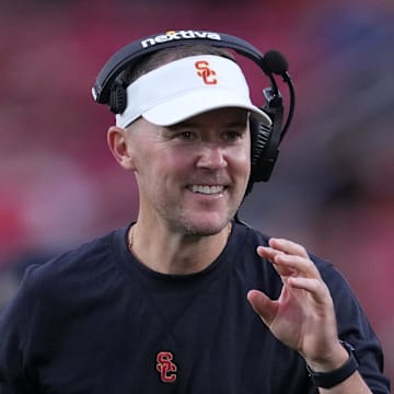 Sep 2, 2023; Los Angeles, California, USA; Southern California Trojans head coach Lincoln Riley (leff) and wide receivers coach Dennis Simmons react against the Nevada Wolf Pack in the second half at United Airlines Field at Los Angeles Memorial Coliseum. Mandatory Credit: Kirby Lee-Imagn Images