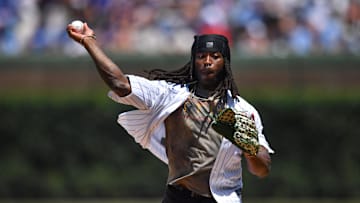 Jul 5, 2025; Chicago, Illinois, USA; New Orleans Saints running back Alvin Kamara throws out a ceremonial first pitch prior to a game between the Chicago Cubs and the St. Louis Cardinals at Wrigley Field. Mandatory Credit: Patrick Gorski-Imagn Images
