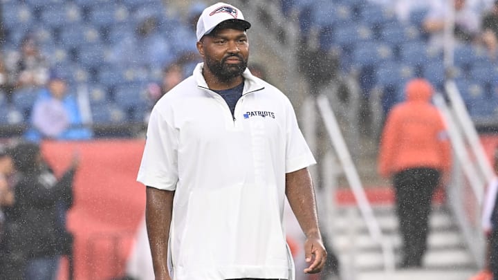 August 8, 2024; Foxborough, MA, USA;  New England Patriots head coach Jerod Mayo  watches as the team warms up before a game against the Carolina Panthers at Gillette Stadium.