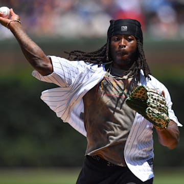 New Orleans Saints running back Alvin Kamara throws out the ceremonial first pitch prior to a game between the Chicago Cubs and  St. Louis Cardinals at Wrigley Field. 