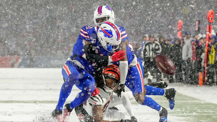 Buffalo Bills safety Jordan Poyer (21) and cornerback Tre'Davious White (27) collide over Cincinnati Bengals wide receiver Tee Higgins (85) as they cover a deep pass in the fourth quarter of the NFL divisional playoff football game between the Cincinnati Bengals and the Buffalo Bills, Sunday, Jan. 22, 2023, at Highmark Stadium in Orchard Park, N.Y. The Bengals won 27-10 to advance to the AFC Championship game against the Kansas City Chiefs.