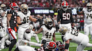 Sep 29, 2024; Atlanta, Georgia, USA; New Orleans Saints running back Alvin Kamara (41) reacts after scoring a touchdown past Atlanta Falcons linebacker Kaden Elliss (55) during the fourth quarter at Mercedes-Benz Stadium. Mandatory Credit: Dale Zanine-Imagn Images