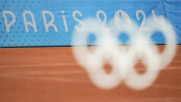 Jul 27, 2024; Paris, France; Olympic rings on the net in women's singles action during the Paris 2024 Olympic Summer Games at Stade Roland Garros. Mandatory Credit: Amber Searls-USA TODAY Sports