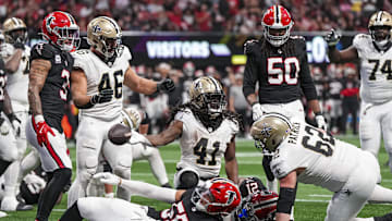 Sep 29, 2024; Atlanta, Georgia, USA; New Orleans Saints running back Alvin Kamara (41) reacts after scoring a touchdown past Atlanta Falcons linebacker Kaden Elliss (55) during the fourth quarter at Mercedes-Benz Stadium. Mandatory Credit: Dale Zanine-Imagn Images