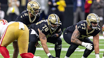 Sep 14, 2025; New Orleans, Louisiana, USA;  New Orleans Saints center Erik McCoy (78) hikes the ball to quarterback Spencer Rattler (2) against the San Francisco 49ers during the second half at Caesars Superdome. Mandatory Credit: Stephen Lew-Imagn Images