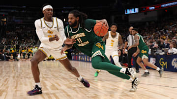 An Atlanta-based travel agent has been charged with fraud as part of a Ponzi-scheme that involved George Mason's men's basketball program.