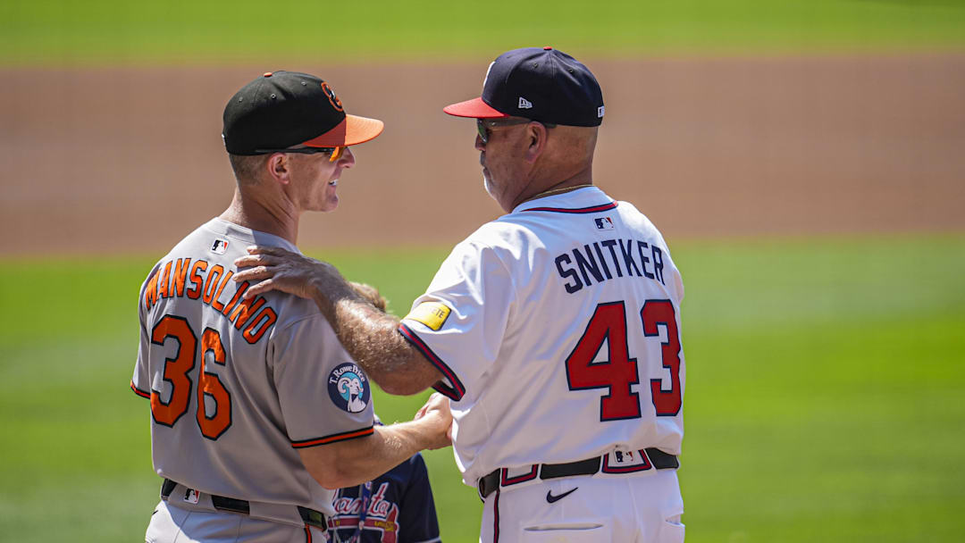 Jul 6, 2025; Cumberland, Georgia, USA; Baltimore Orioles interim manager Tony Mansolino (36) and Atlanta Braves manager Brian Snitker (43) meet on the field before the game at Truist Park. Mandatory Credit: Dale Zanine-Imagn Images