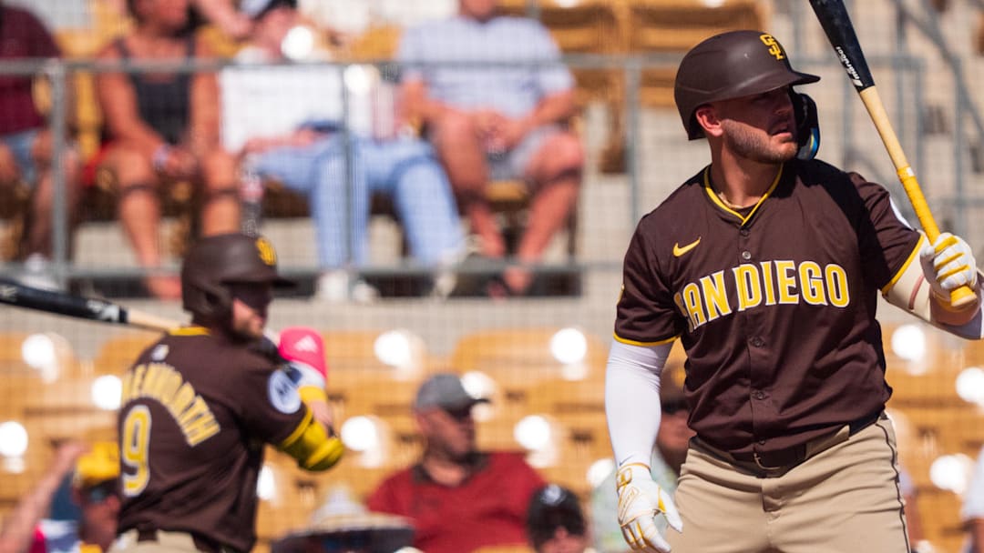 Feb 26, 2025; Phoenix, Arizona, USA;  San Diego Padres infielder Mike Brosseau (20) prepares for his at bat in the second inning as infielder Jake Cronenworth (9) watches on from the on deck circle as during a Spring Training game against the Chicago White Sox at Camelback Ranch. Mandatory Credit: Allan Henry-Imagn Images